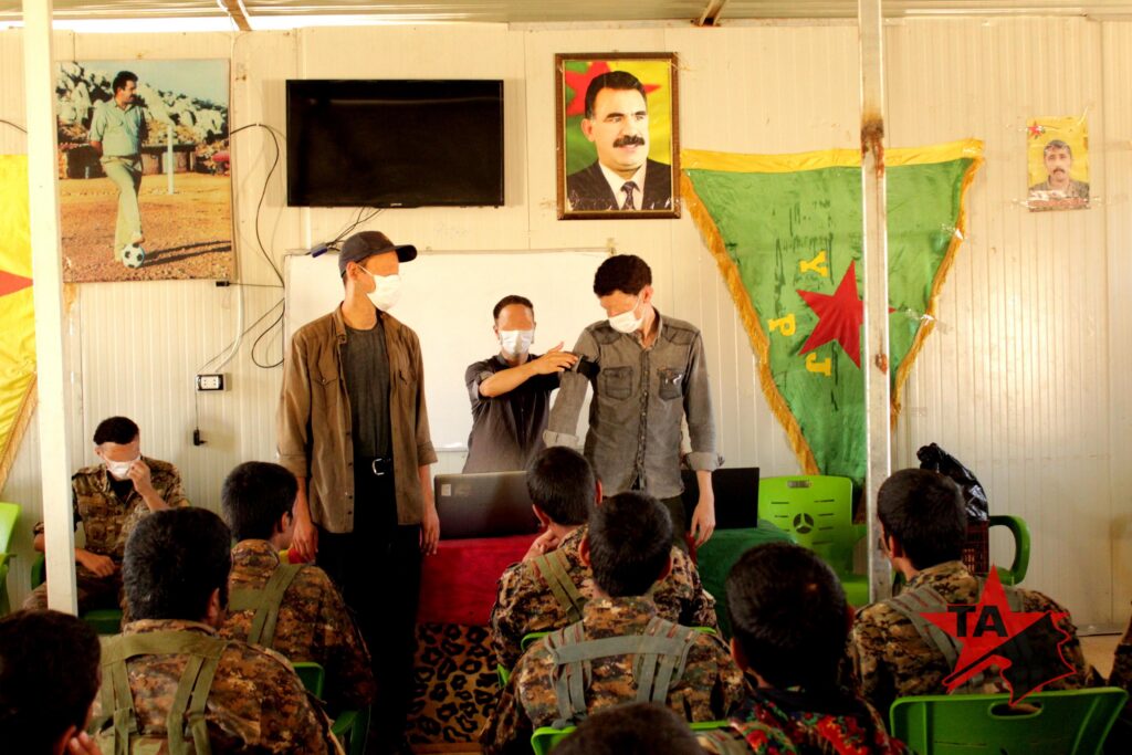 a photo of volunteers conducting a medical training for YPG members