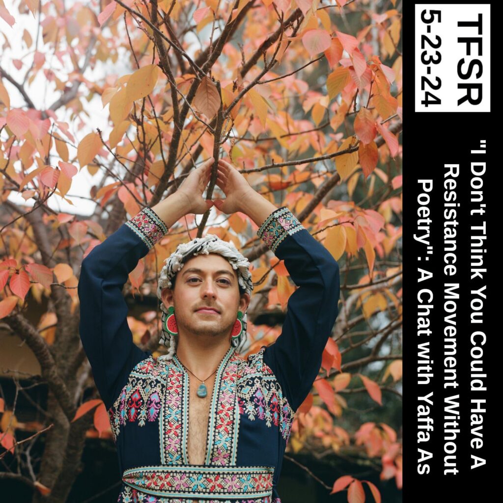Photo by María Del Río of Yaffa with hands raised above their head grasping the branch of an tree in autumn